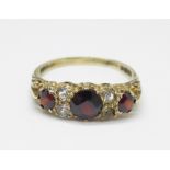 A 9ct gold, garnet and white stone ring, 2.4g, T