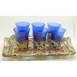 Six oriental tea glass holders on a tray, decorated with dragons and blossom, one glass a/f