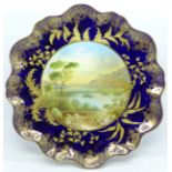 An Aynsley cabinet plate, with a blue and gold border having a central hand painted landscape,