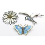 Three Norwegian silver and enamel brooches, including a bird and a flower by David Andersen