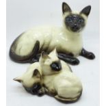 Two Royal Doulton Siamese cat figures, smaller figure with small chip to one ear