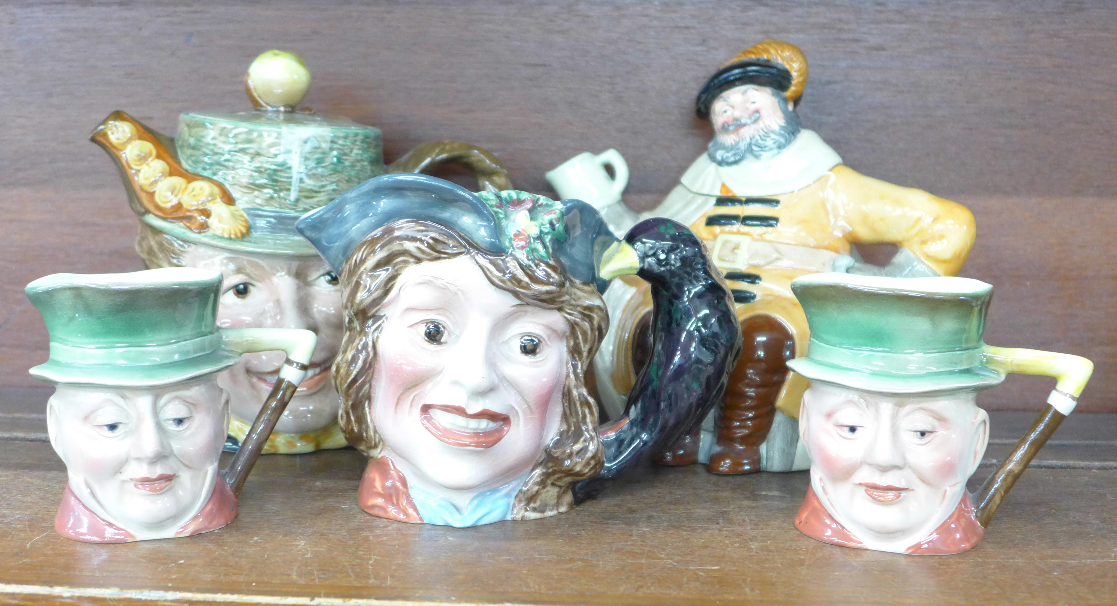 A Beswick and a Royal Doulton character teapot and three Beswick character mugs