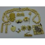 A collection of bone and ivory brooches, earrings, pendants, necklace and stick pin