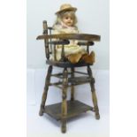 A composite doll and a doll's wooden baby chair