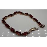 A 9ct gold and fire garnet bracelet, 12.2g