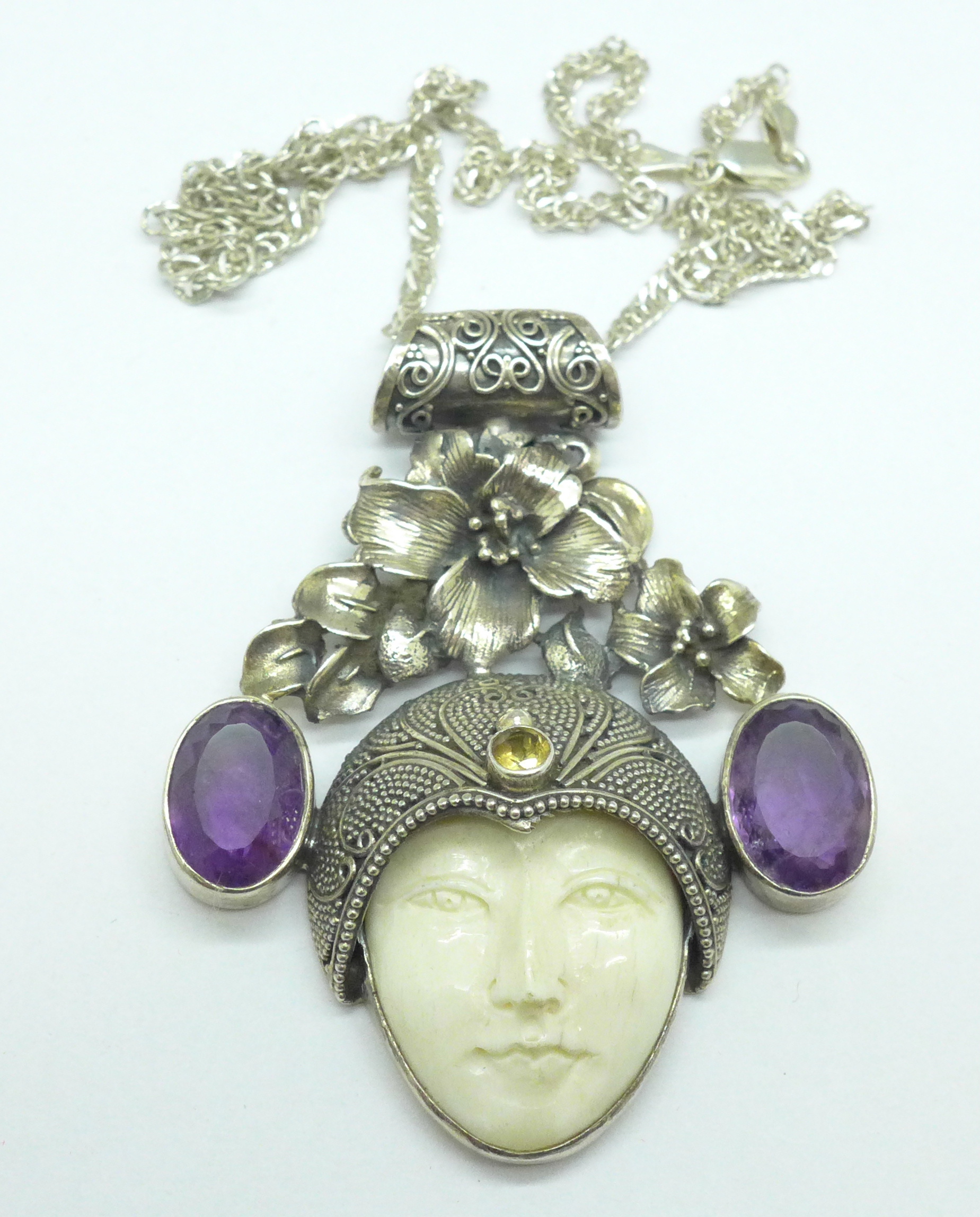 An Art Nouveau style silver pendant and chain set with amethyst
