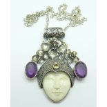 An Art Nouveau style silver pendant and chain set with amethyst