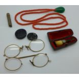 A string of coral beads with a jade pendant, two Pinz Nez spectacles, a Victorian cheroot holder and