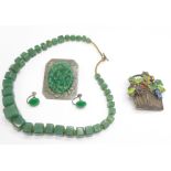 A Chinese silver and enamel flower basket brooch, a jade coloured necklace and earrings, and a