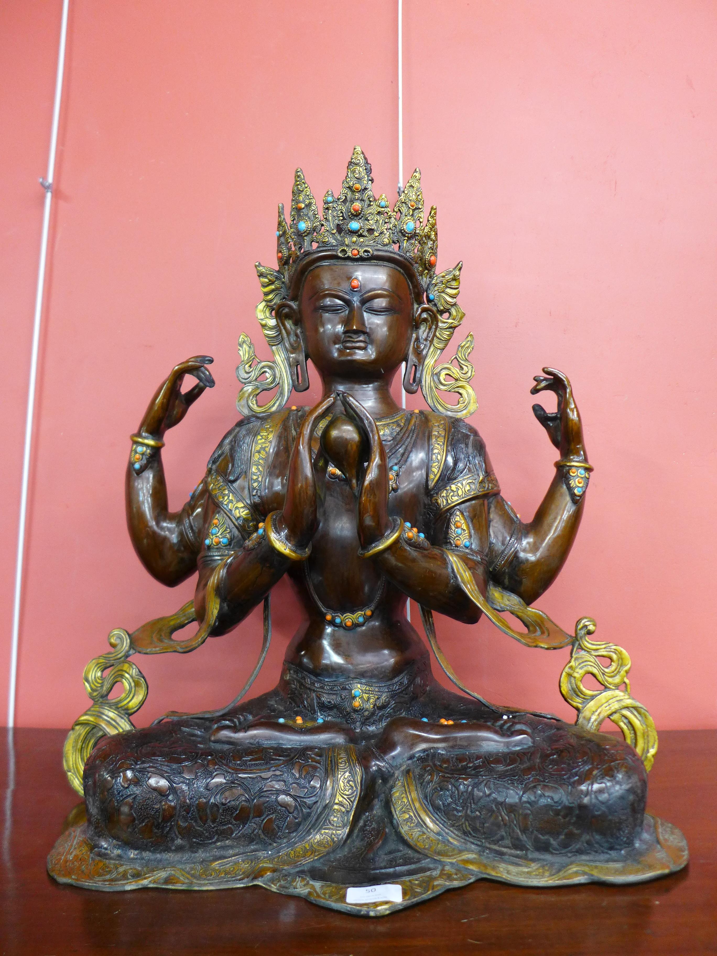 An oriental bronze figure of a deity