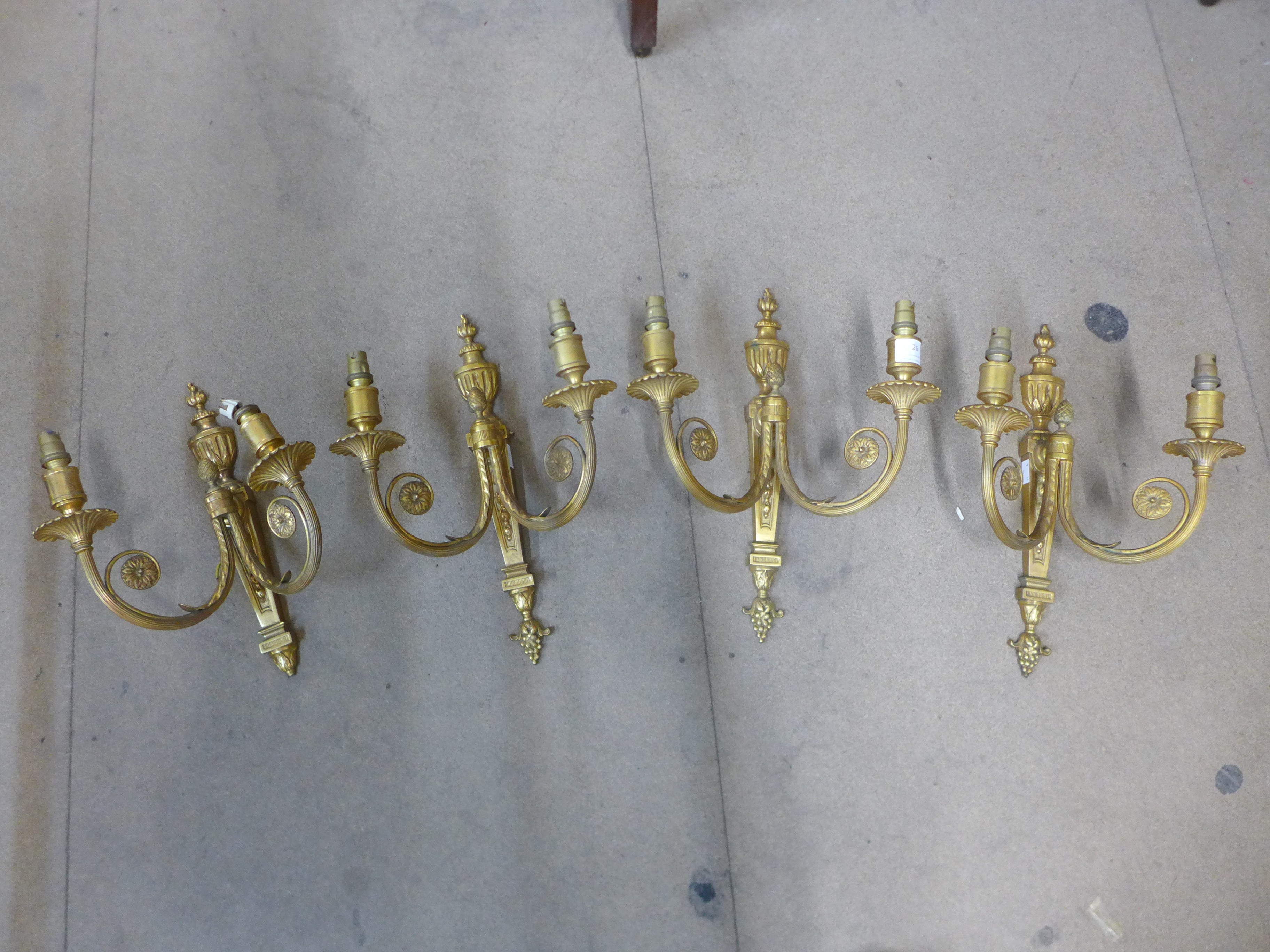 A set of four gilt metal wall sconces