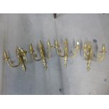 A set of four gilt metal wall sconces