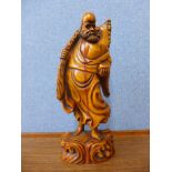 An oriental carved wooden figure of a sage