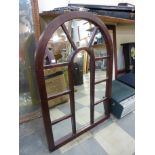 A mahogany cathedral style mirror