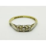 An 18ct gold and platinum set three stone diamond ring, 2.4g, O