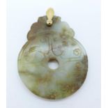 A jade pendant with yellow metal loop