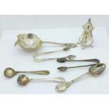 A silver tea strainer, silver pepper, silver spoons and two pairs of silver sugar bows, 130g