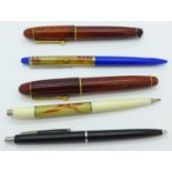 A collection of pens including two novelty
