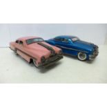 Two tin-plate friction model sedan cars