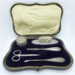 A cased silver manicure set