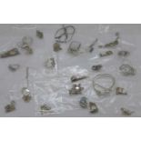 Twenty five silver pendants and chains