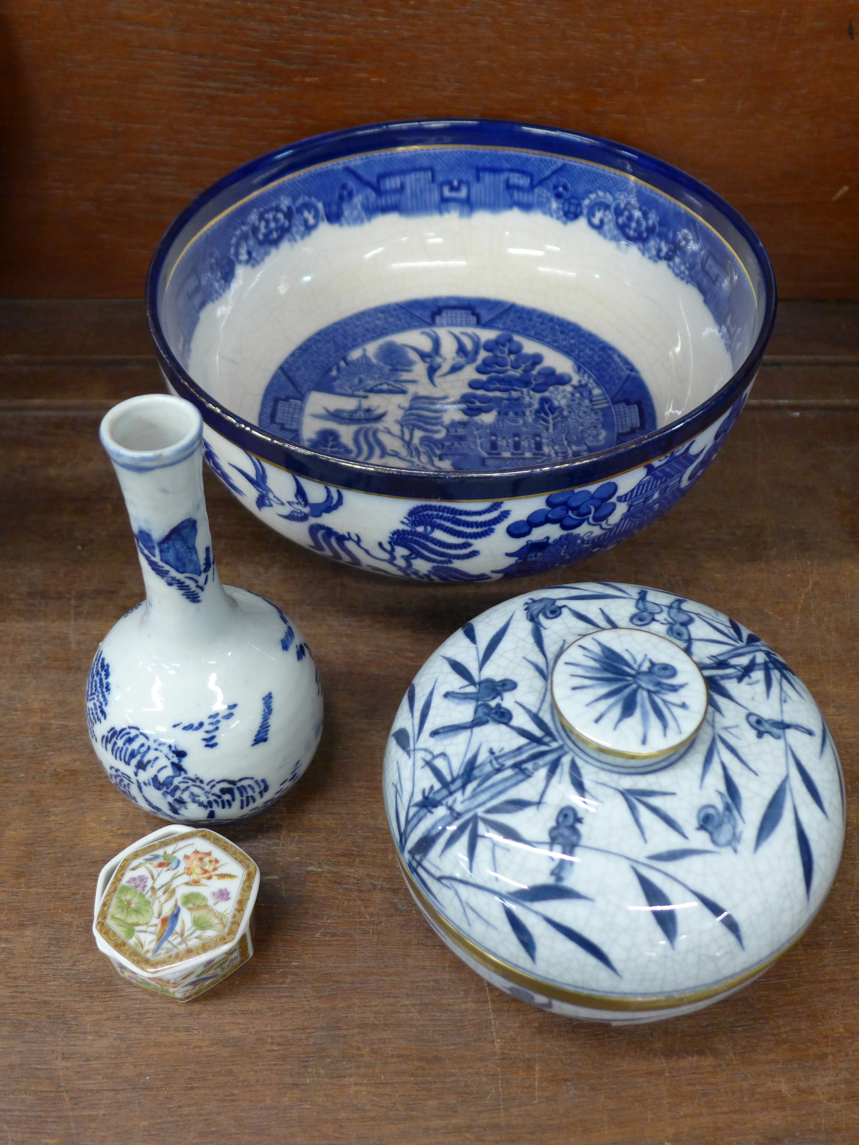 A Booths willow pattern bowl, an oriental blue and white vase, lidded pot and trinket box