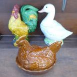 A Border Fine Arts duck biscuit jar and cover, a hen egg container and a majolica figure of a