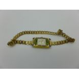 A lady's Manis 18ct gold and enamel wristwatch