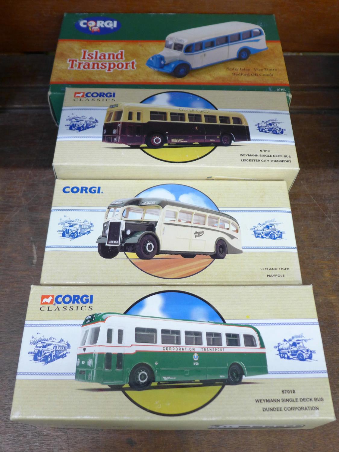 Four Corgi model buses including Island transport