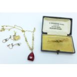 A 9ct gold brooch, a pair of 9ct gold earrings, a yellow metal charm and a 9ct gold, pearl and red