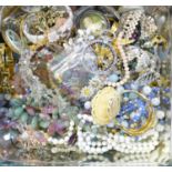 A tin of costume jewellery