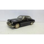 A black tin-plate model sedan car