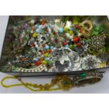 A tin of costume jewellery