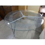 A steel and glass topped circular coffee table