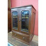 A mahogany counter top shop cabinet, bearing Asprey Jewellers, London inscription to doors