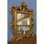 A rococo style gilt framed mirror