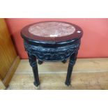 A 19th Century Chinese carved rosewood and marble topped jardiniere stand