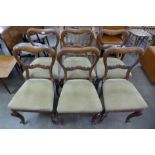 A set of six early Victorian oak kidney shaped back dining chairs