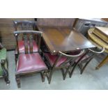 An oak draw leaf table and four chairs