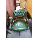 A mahogany and green leather swivel office chair