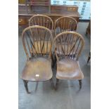 A Harlequin set of four 19th Century elm Windsor kitchen chairs