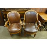 A pair of oak and upholstered library chairs