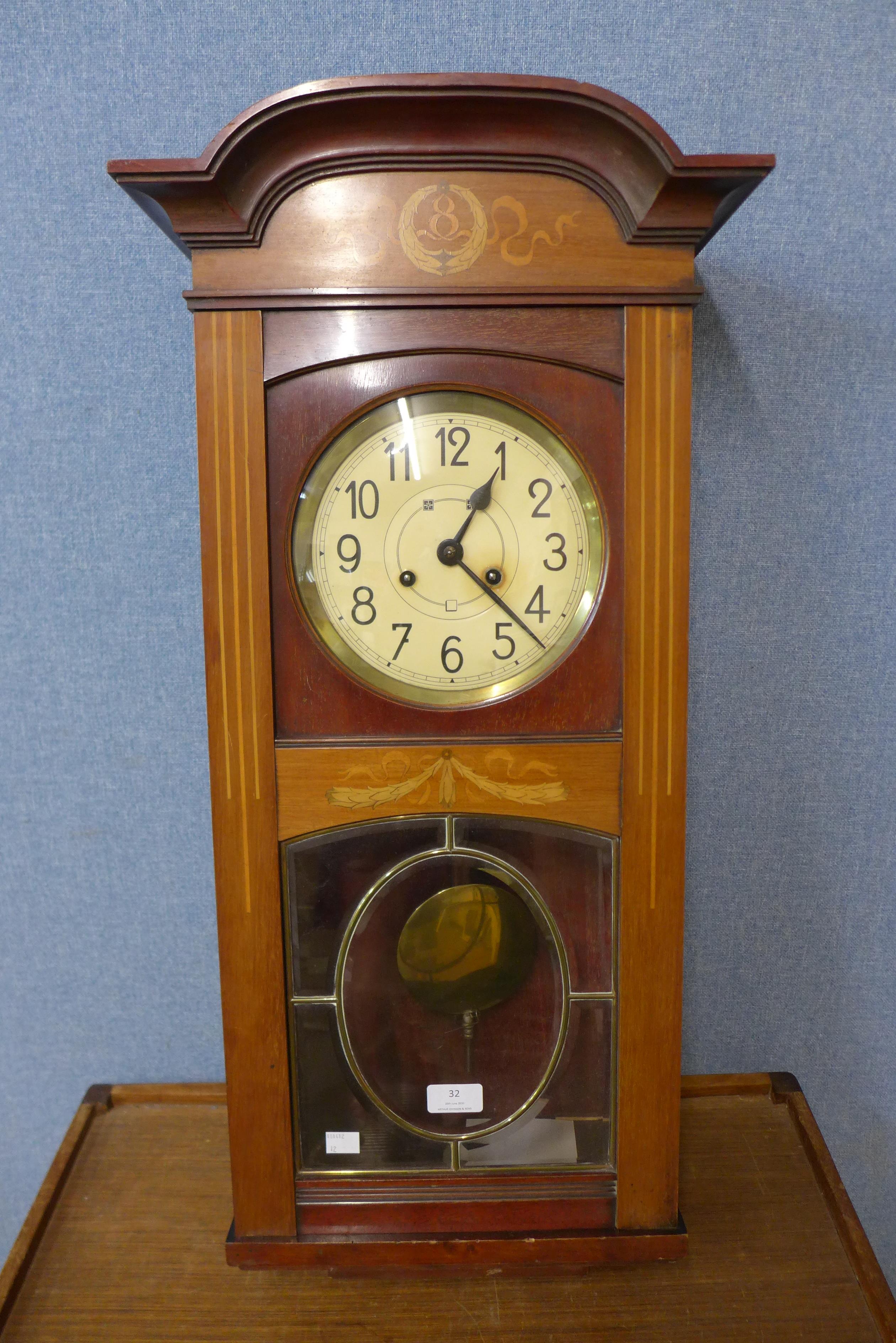 A Secessionist inlaid mahogany wall clock