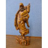 An oriental carved wood figure of a sage
