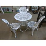 A painted cast aluminium garden table and three chairs