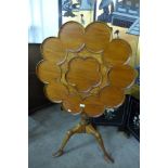 An Irish style inlaid walnut tilt top tea table