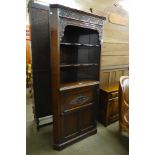 A 17th Century style carved oak freestanding corner cabinet