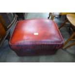 A red leather ottoman