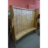 A 19th Century style pine curved bacon settle