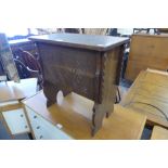 A carved oak box stool